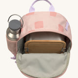 The inside of the Lassig kids mini rose pattern party backpack showing various items  inside the main compartment with a bottle in the mesh side pocket
