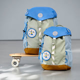 2 Lassig kids mini outdoor backpack in sunny explorer green on a mini skateboard