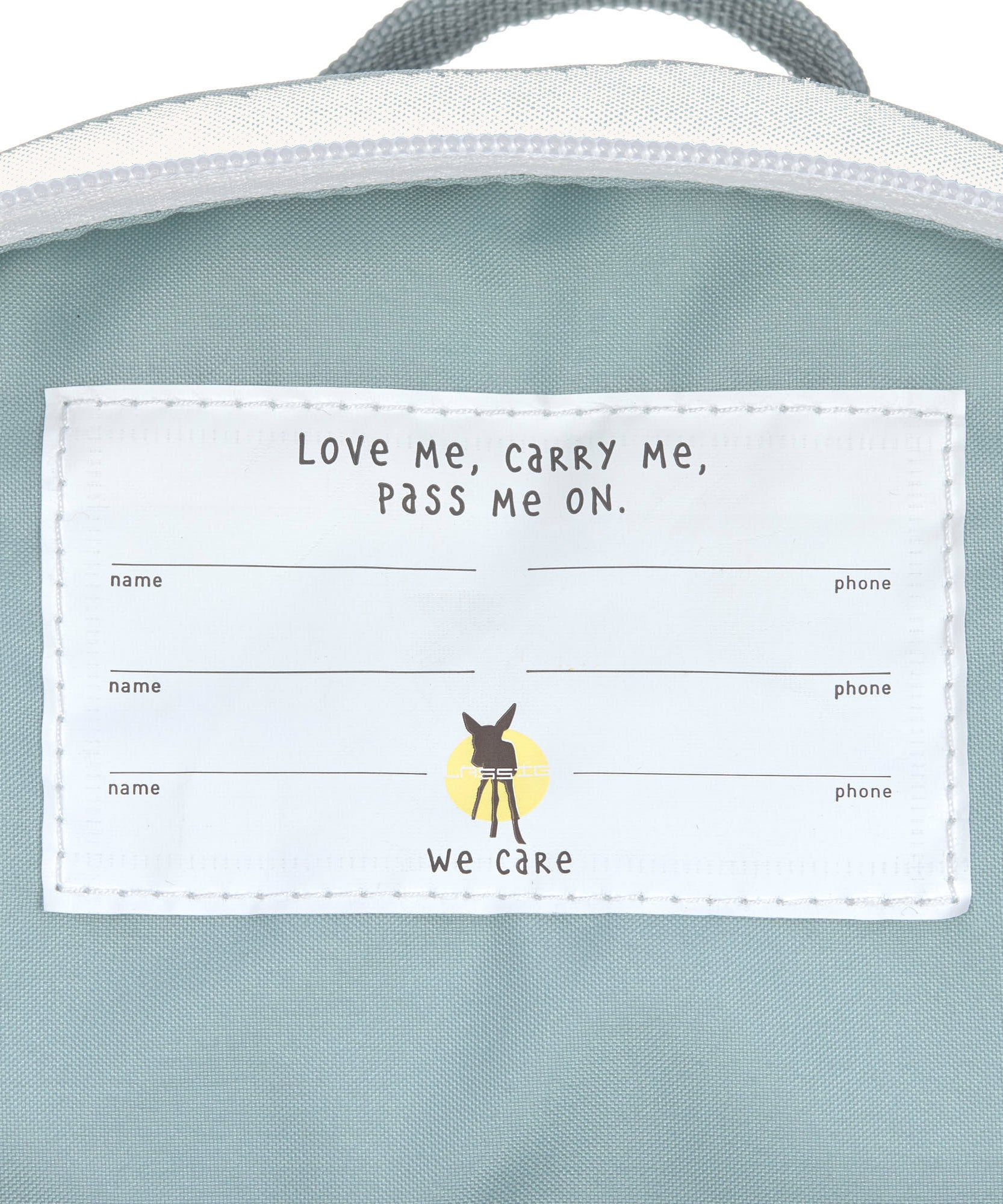 A close up of the name tag on the inside of the Lassig kids tiny backpack in penguin.