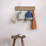 Lassig kids tiny backpack in penguin and whale available at Babipur handing on hookd with a wooden stool underneath