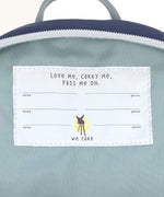 A close up of the name tag on the inside of the Lassig kids tiny backpack in whale.