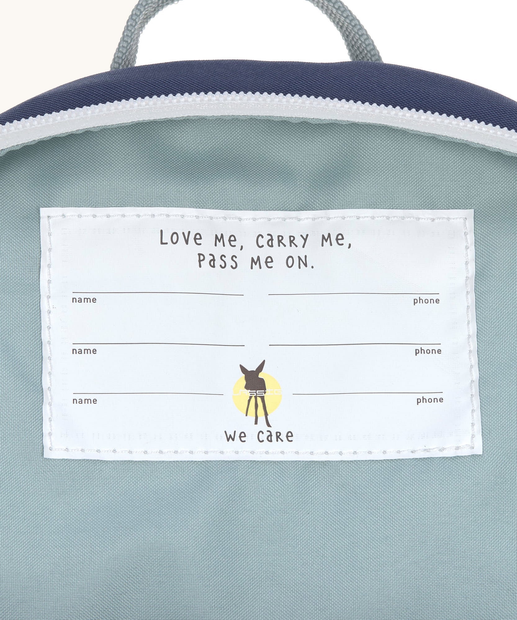 A close up of the name tag on the inside of the Lassig kids tiny backpack in whale.