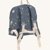 The back of the Lassig kids mini midnight blue happy prints backpack showing the padded shoulder straps and chest strap detail.