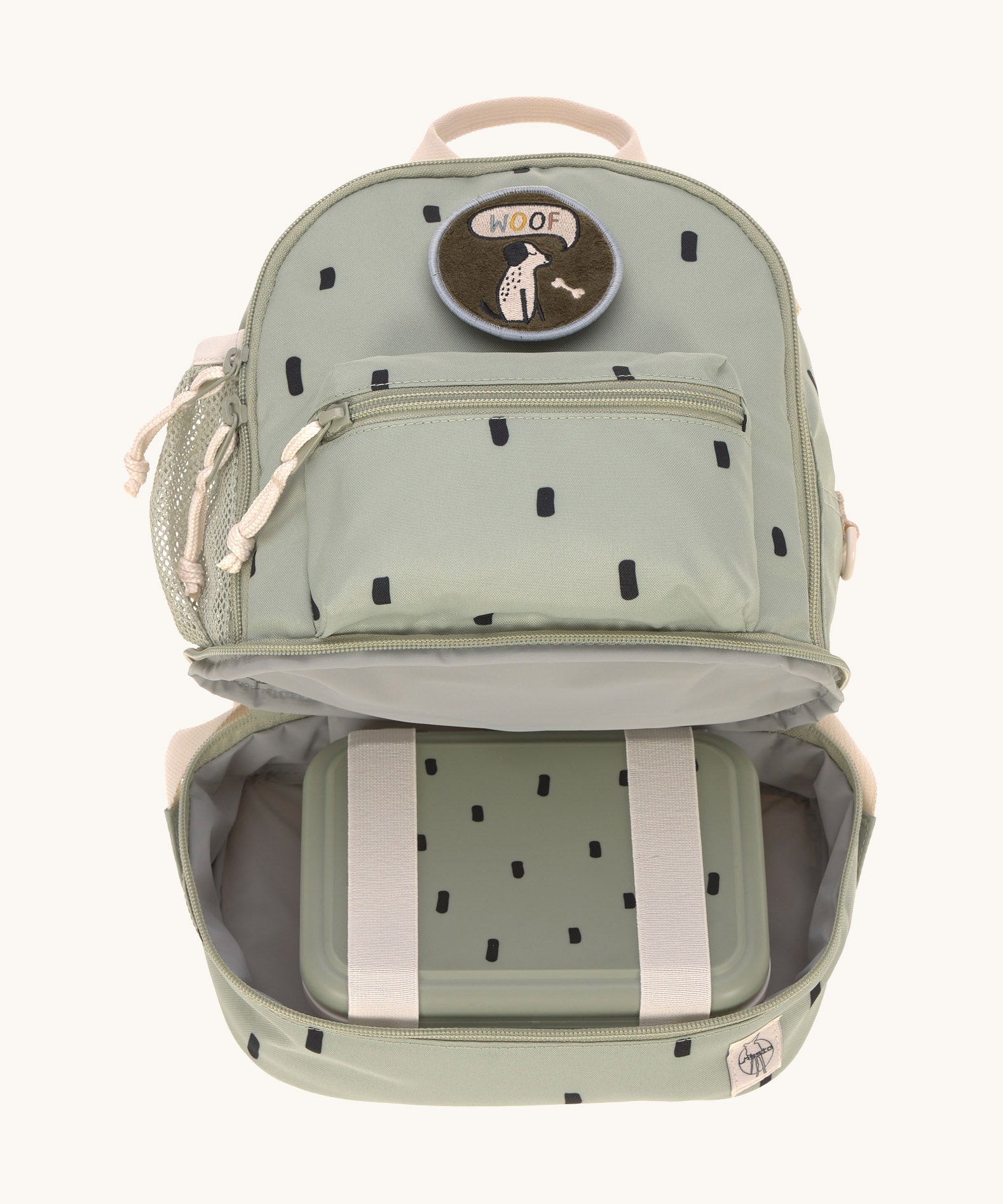 The inside of the Lassig kids mini olive happy print backpack showing a lunchbox inside the bottom compartment.