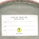 A close up of the Lassig kids mini rose party pattern backpack showing the white name tag on the inside