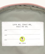 A close up of the Lassig kids mini rose party pattern backpack showing the white name tag on the inside