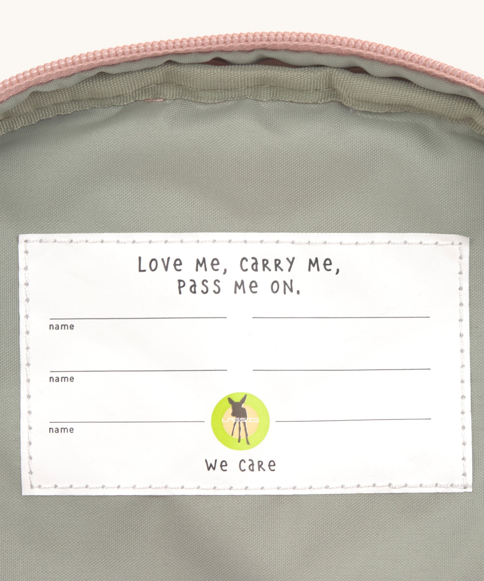 A close up of the Lassig kids mini rose party pattern backpack showing the white name tag on the inside