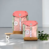 2 Lassig kids mini outdoor backpack in sunny explorer pink on a mini skateboard