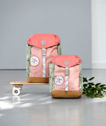 2 Lassig kids mini outdoor backpack in sunny explorer pink on a mini skateboard