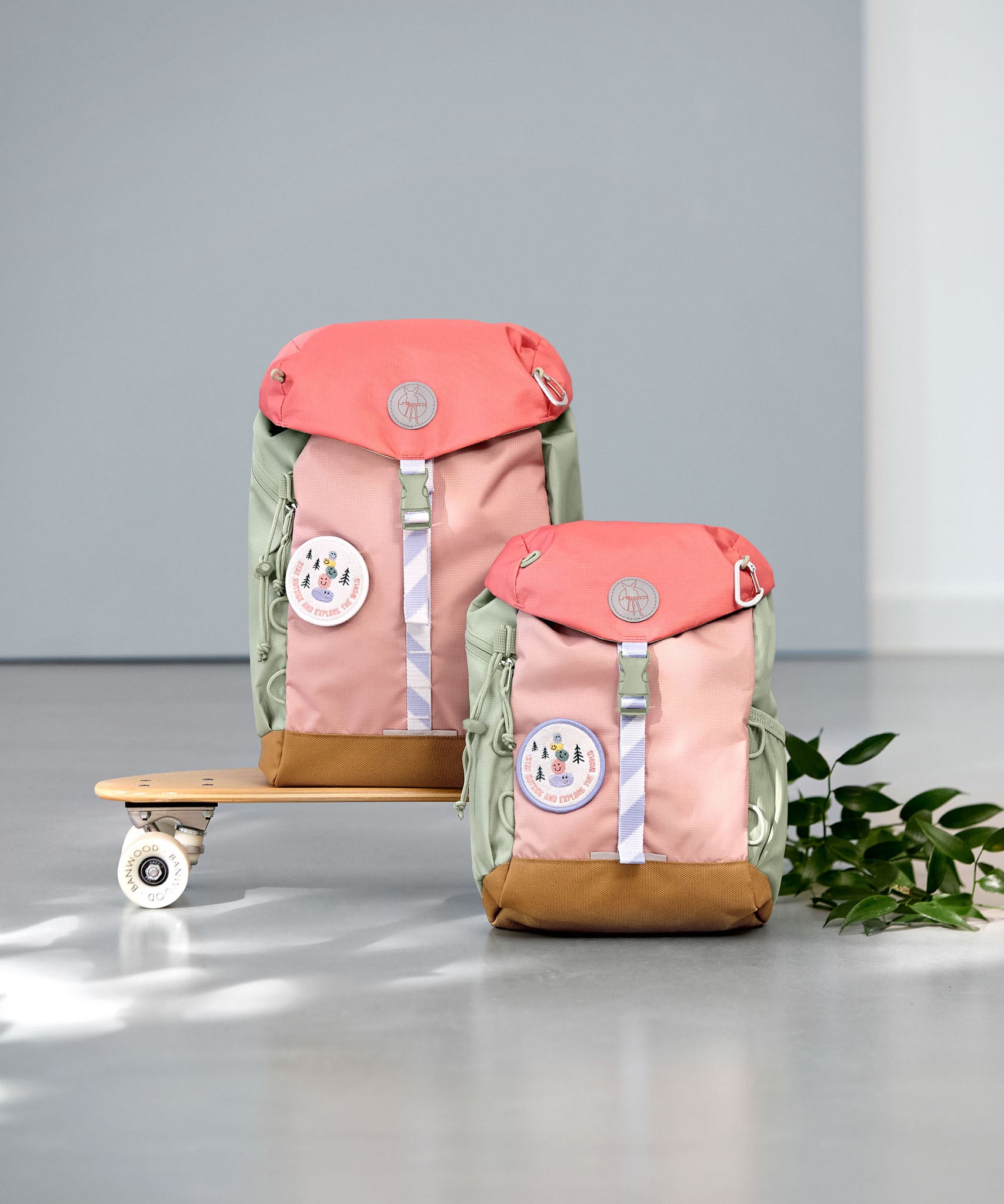 2 Lassig kids mini outdoor backpack in sunny explorer pink on a mini skateboard