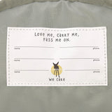 A close up of the Lassig kids mini midnight blue happy print backpack showing the white name tag detail on the inside