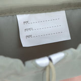 A close up of the name tag on the Lassig kids mini outdoor backpack.