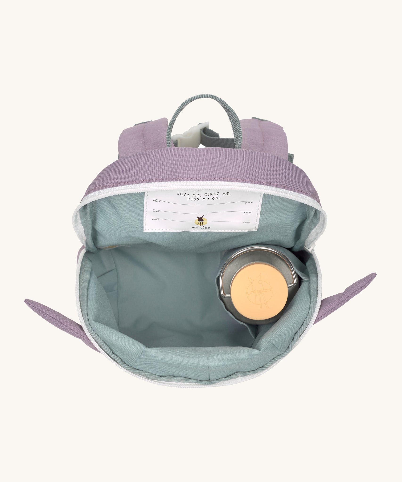A close up of the Lassig kids tiny bunny backpack showing the bottle holder detail inside the backpack