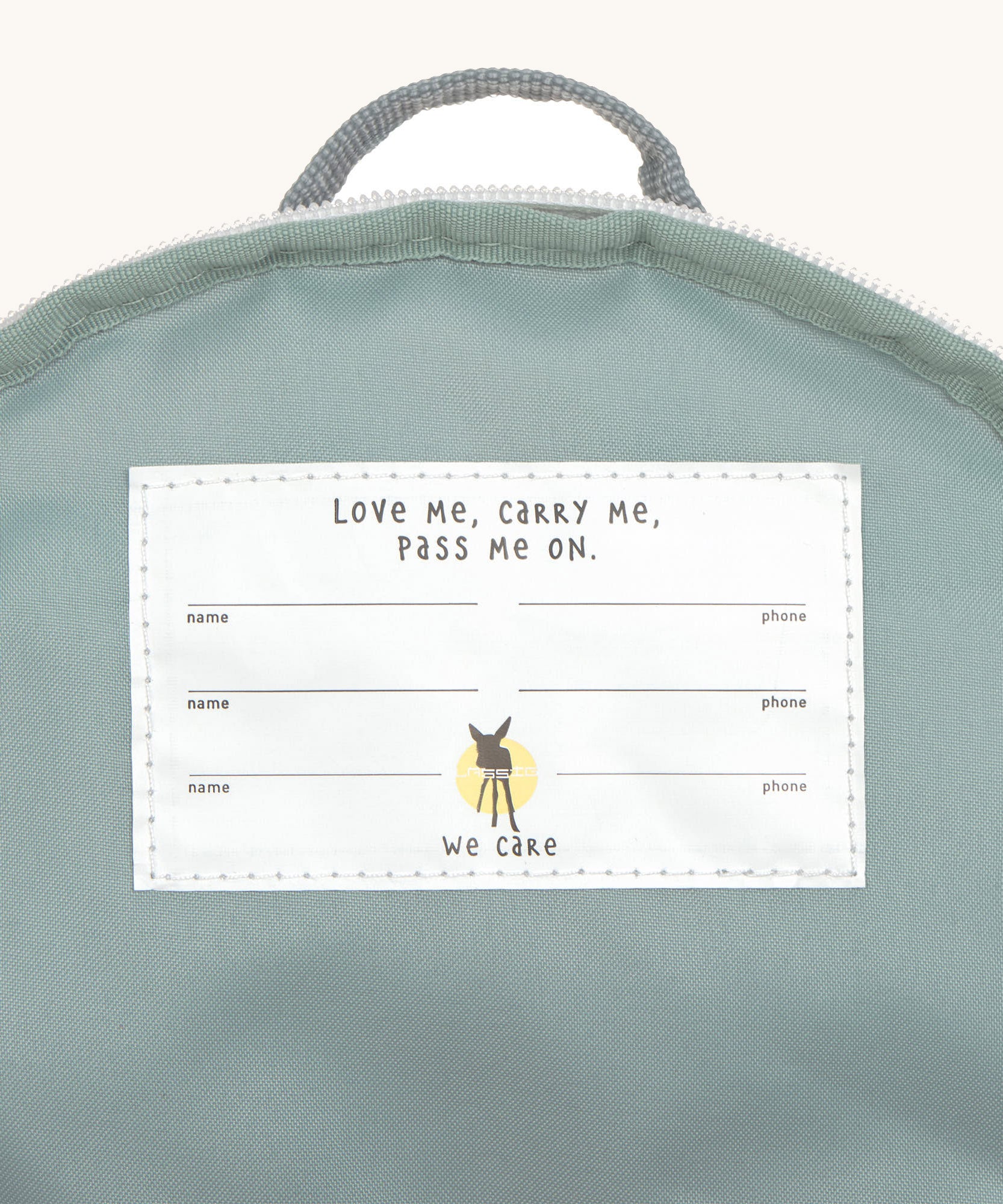 A close up of the white name tag inside the Lassig tiny digger backpack.