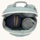 A close up of the Lassig kids tiny backpack in penguin showing the bottle holder detail and space inside the main compartment of the backpack