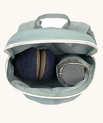 A close up of the Lassig kids tiny backpack in penguin showing the bottle holder detail and space inside the main compartment of the backpack