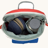 A close up of the Lassig kids tiny fire engine backpack showing the bottle holder detail and space inside the main compartment of the backpack