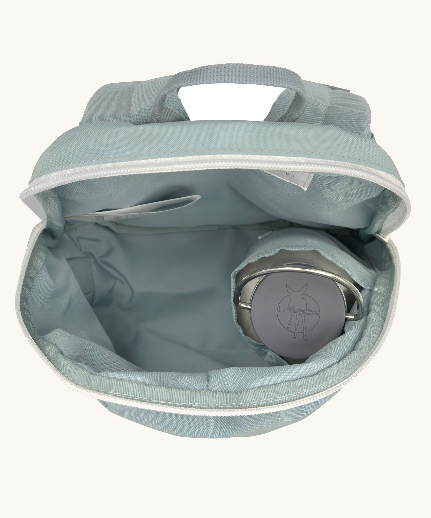 A close up of the Lassig kids tiny backpack in penguin showing the bottle holder detail inside the backpack