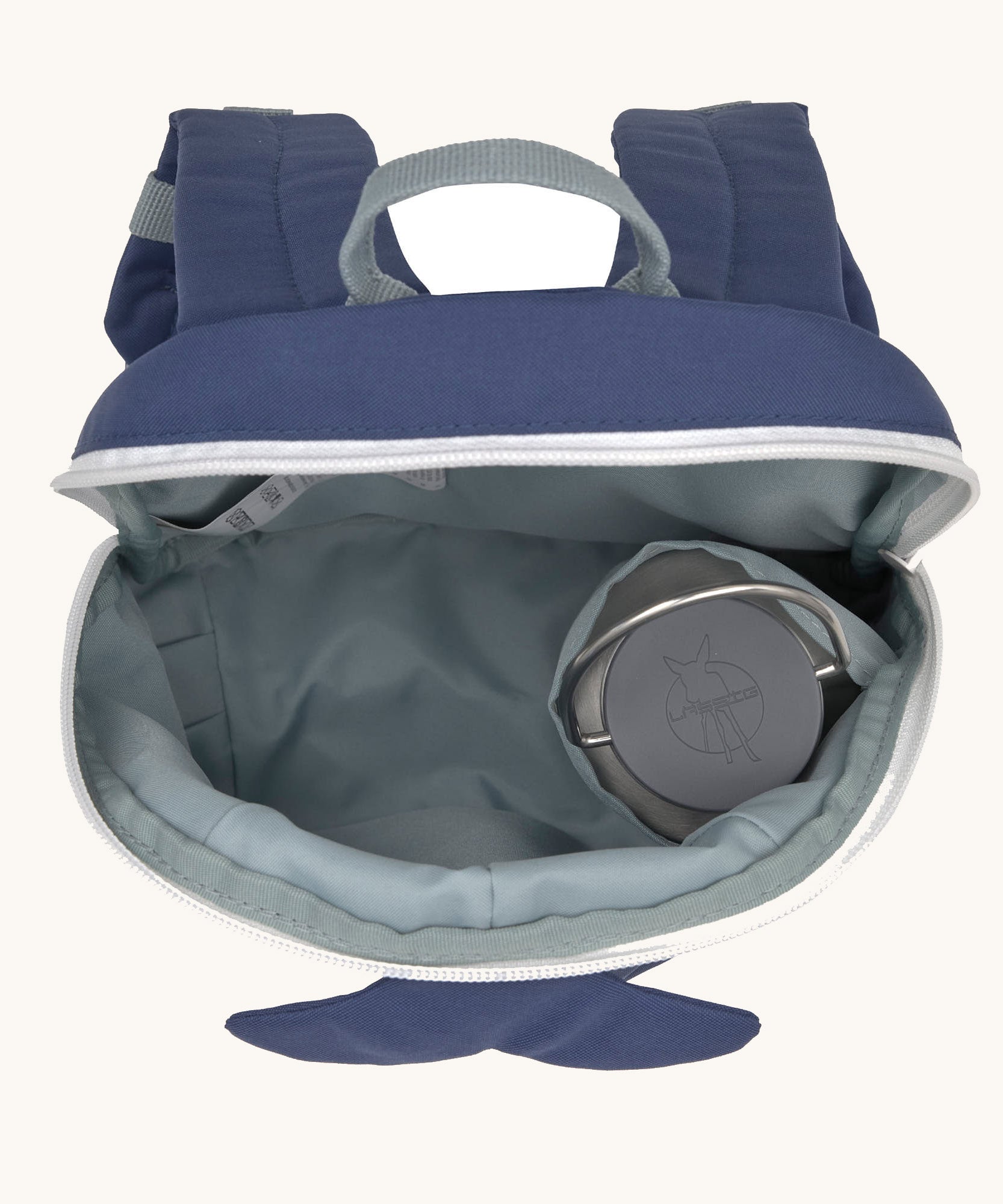 A close up of the Lassig kids tiny backpack in whale showing the bottle holder detail inside the backpack