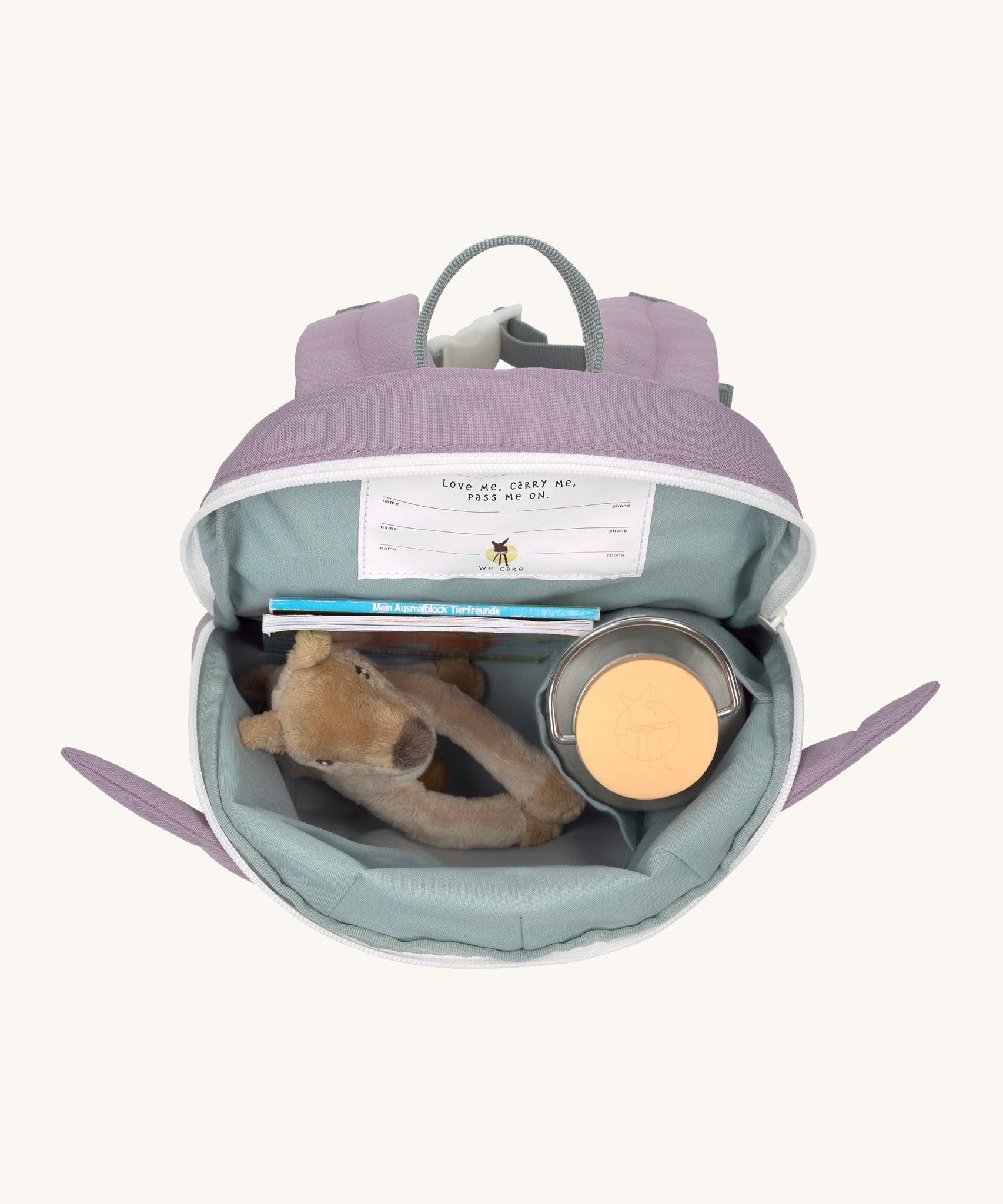 A close up of the Lassig kids tiny bunny backpack showing the bottle holder detail and space inside the main compartment of the backpack