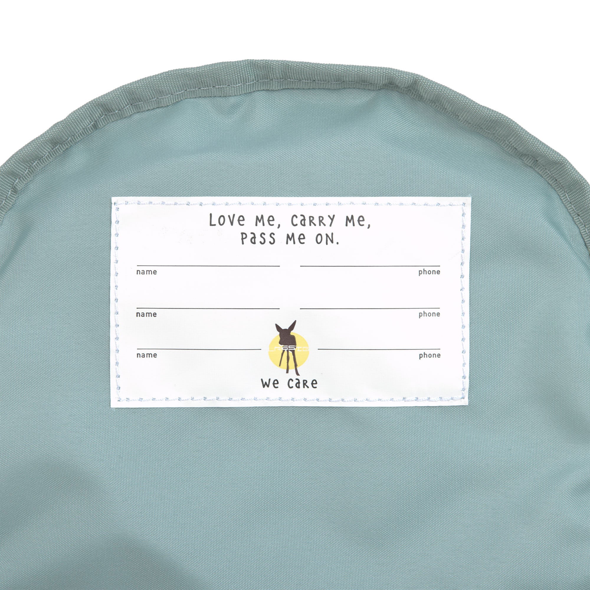 The inside label of the Lassig tiny backpack for toddlers and little kids, in a light pink.