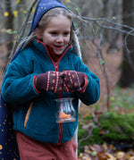 Child in a forest wearing Knitted Mittens in Brown with red flowers by Little Green Radicals - made from warm GOTS organic and Fairtrade certified cotton - available now at Babipur.