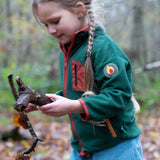 Girl running around a forest wearing Polar Fleece Jacket in Olive green by Little Green Radicals, made from recycled fleece, available now at Babipur.