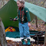 Girl camping in a forest wearing Little Green Radicals Kids Polar Fleece Jacket in Olive green with a red pocket and zip, buy now at Babipur.