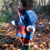 Baby in a forest wearing a hooded Little Green Radicals Waterproof Winter School Coat, with elasticated sleeves, made from recycled bottles, with a Moonlight Blue print with large pockets in deep red, for sale at Babipur.