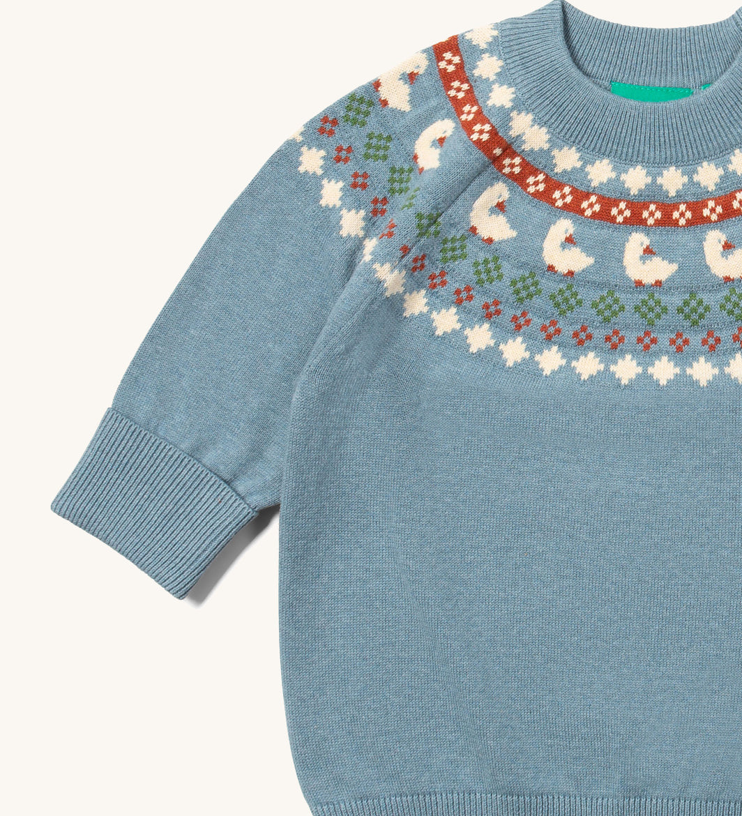 A close up of the Little Green Radicals fairisle knitted jumper in little ducks available at Babipur showing the fairisle design and elasticated cuff detail.
