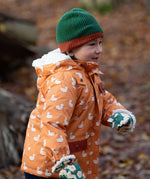 Child running through a forest wearing a chive green with a crimson trim Knit Beanie by Little Green Radicals with a red trim and matching scarf - made from soft GOTS organic and Fairtrade certified cotton - for sale at Babipur.