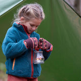 Child in a forest wearing Little Green Radicals Knitted Mittens in Brown Collecting Flowers - made from warm GOTS organic and Fairtrade certified cotton - shop at Babipur.