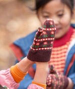 Close up of a child's hand wearing a knitted brown and red floral mitten from the Little Green Radicals Autumn Winter 2025 range - made from GOTS organic and Fairtrade certified cotton, available now at Babipur.
