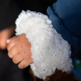 Close up of child's hands, wearing Little Green Radicals Waterproof Winter School Coat, with a cozy recycled polyester lining, made from recycled bottles, with a Moonlight Blue print, PFC Free, for sale at Babipur.