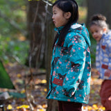 Child in a forest wearing a Little Green Radicals Waterproof Winter Coat in a turquoise Winter Rabbits print, with a cosy fluffy hood, made from recycled bottles and a cosy polyester fleece, for sale at Babipur.