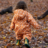 Back of child running in a forest wearing a Gold Ducks Hooded Waterproof Winter Suit in print, by Little Green Radicals, with and a cosy polyester fleece, for sale at Babipur.