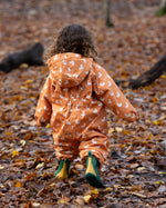 Back of child running in a forest wearing a Gold Ducks Hooded Waterproof Winter Suit in print, by Little Green Radicals, with and a cosy polyester fleece, for sale at Babipur.