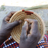 A look at the hand making process of weaving the copper wire to create a part of the bowl