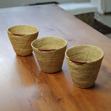 3 MADE51 Small Handmade Makenge Basket on a wooden table, stood in a row