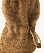 Mamalila Baby Wool Booties - in camel brown. Baby booties made from upcycled boiled wool available at Babipur. Photo shows elastic pull string ankle fastening