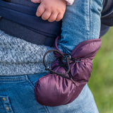 A close up of a baby wearing the Mamalila quilted Berlin booties in berry colour available at Babipur. Showing the toggle fastener detail