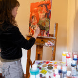 An artist using the Natural Earth Paint acrylic paint on a canvas