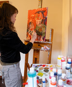 An artist using the Natural Earth Paint acrylic paint on a canvas