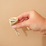 Person demonstrating how to fold a HEVEA LOOP menstrual cup.