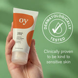The OY! Clear Skin Cleansing Moisturiser pictured in a persons hand with a Dermatologically tested logo