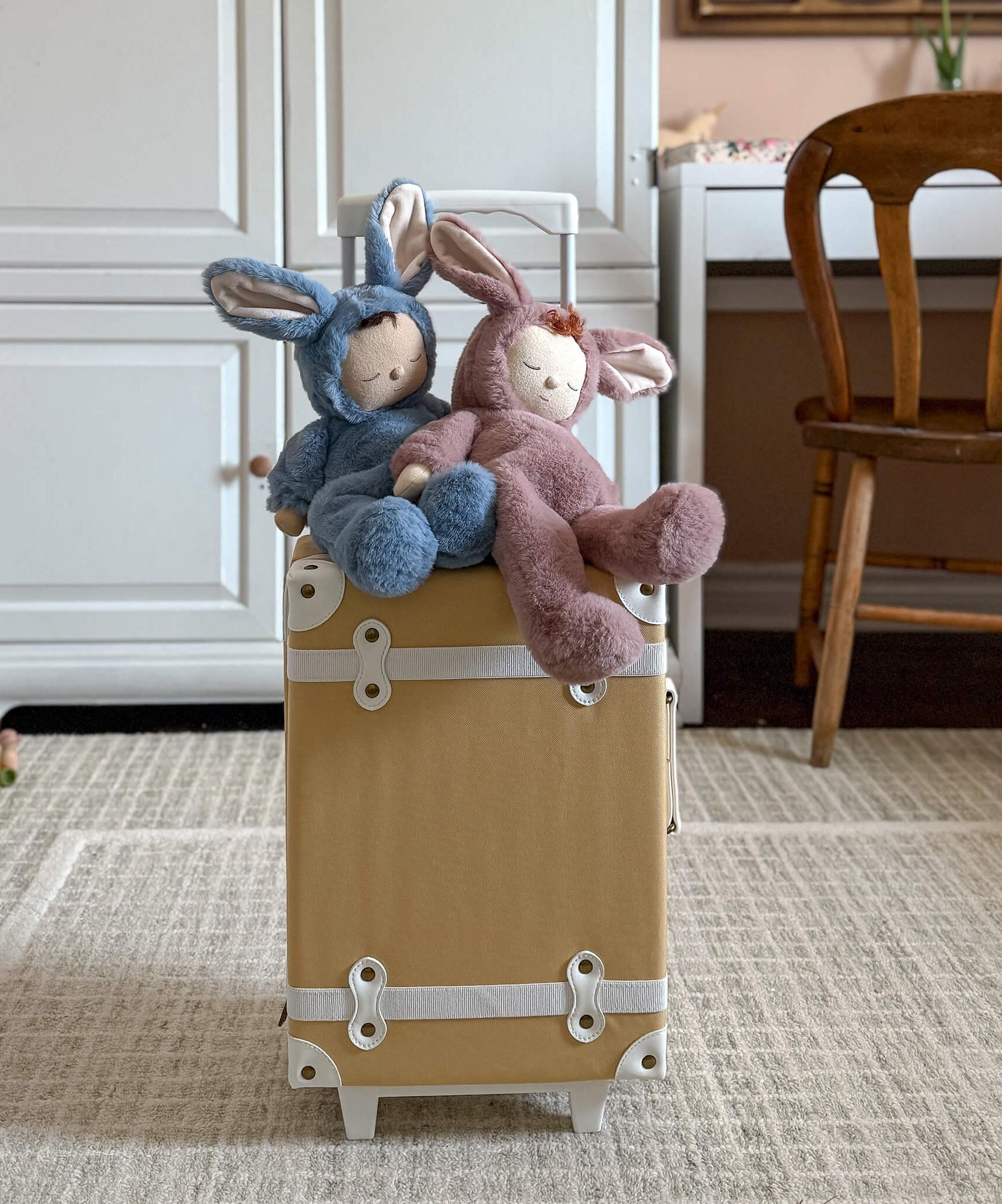 Olli Ella cozy dinkum bunny pickle and twiggy doll sitting on top of a Olli Ella suitcase. These fluffy toy dolls are available at Babipur