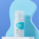 The Green People OY! Organic Teen Deodorant on a wavy blue background, and stood on a white box shelf
