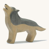 A wooden Ostheimer howling grey wolf figure on a cream background