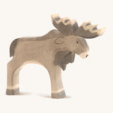 A wooden Ostheimer standing moose figure on a cream background.