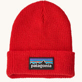 Patagonia little kids logo beanie in sizzle red available at Babipur. A 100% recycled polyester soft knit beanie in bright red with a brand patch on the turned up brim